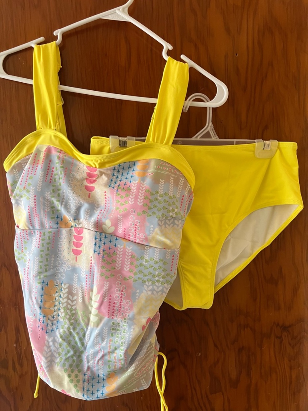 Tankini with pastel colors and rushing on the side with yellow bottoms.